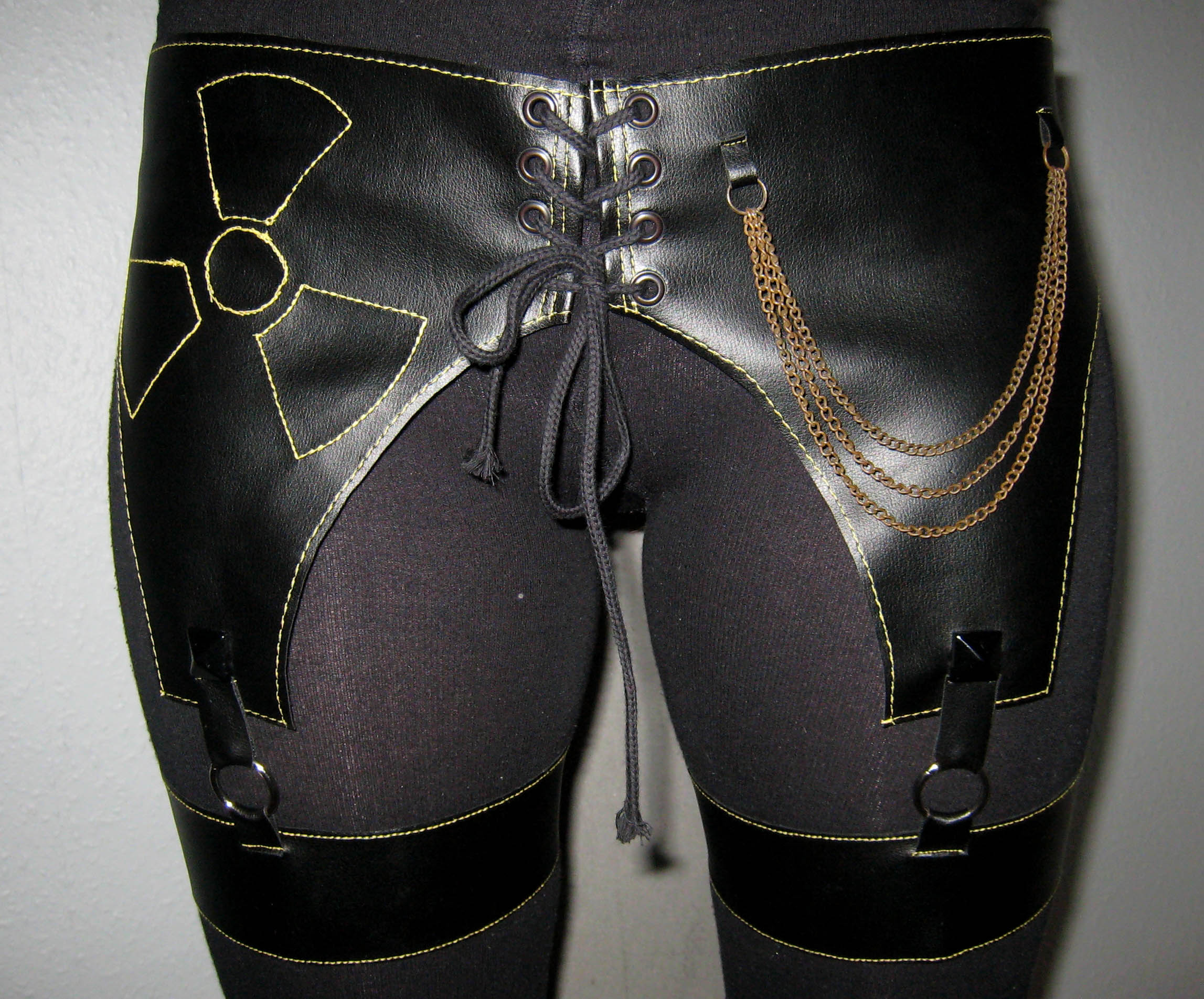 Garter belt in black fauxleather with chains and yellow details ...
